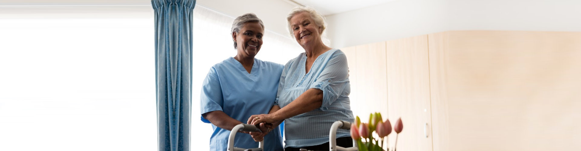 caregiver assisting a senior woman