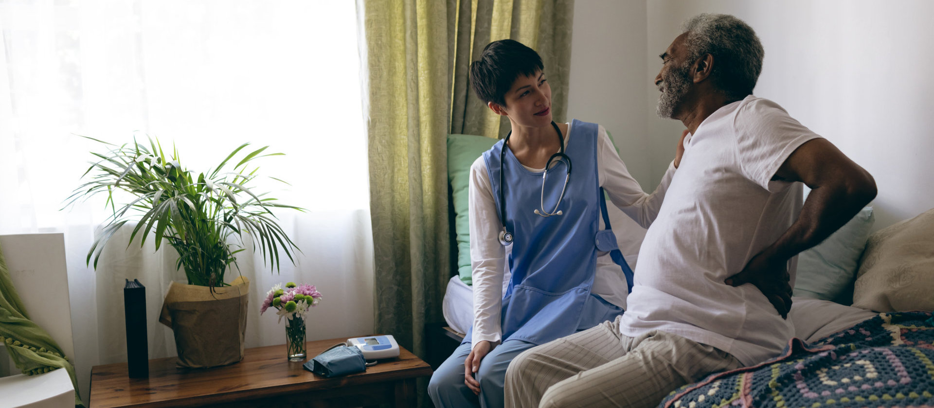 Senior male touches his back to show that it hurts.