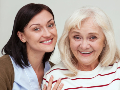 caregiver smiling with elderly woman